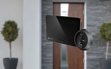 The EZVIZ EP4 peephole camera is mounted on a door with its wireless monitor displaying live footage and settings.