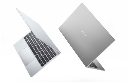 A closed Dell XPS 13 laptop displays its slim silver chassis and touchscreen.