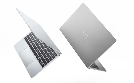A closed Dell XPS 13 laptop displays its slim silver chassis and touchscreen.