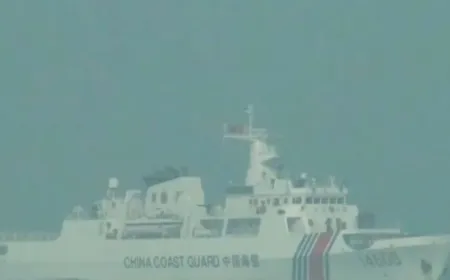 Chinese coast guard vessels navigate near Taiping Island during heightened territorial disputes in the South China Sea.