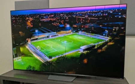 Television screen showing a football match with high brightness and motion clarity.