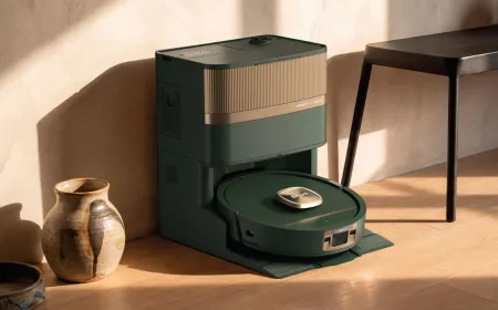 This product image shows a robot vacuum with a satin metallic finish and muted color palette.