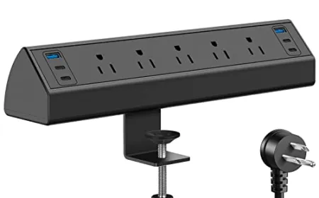 A desk-mounted power strip is installed beneath a workstation with multiple outlets and cable management channels.