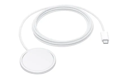 Apple MagSafe charger with a 2 meter cable resting on a charging pad