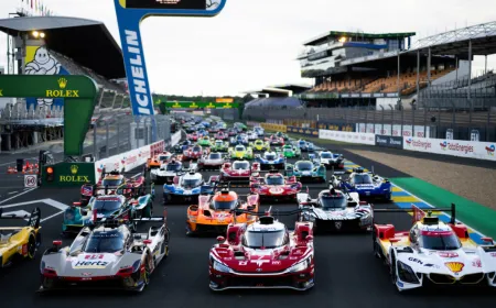Spectators watch racing cars compete during the day and night at the 24 Hours of Le Mans.