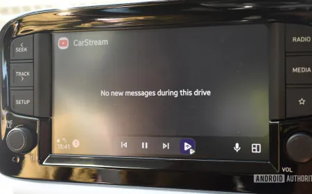 A smartphone displays the Android Auto interface while connected to a vehicle.