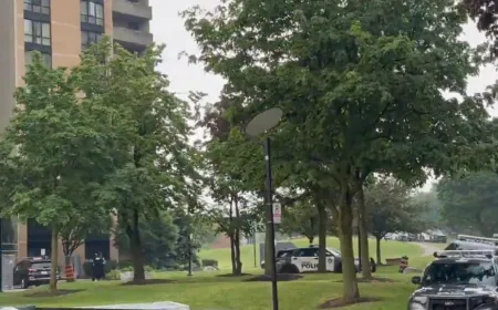 Toronto police officers at a residential property during a warrant execution