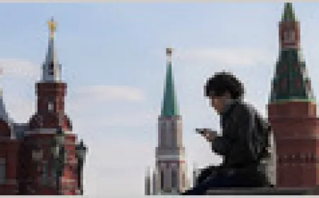 A Russian interior designer uses a virtual private network in a quiet cafe to bypass internet restrictions.