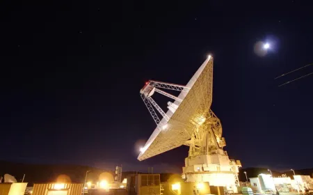A NASA Deep Space Network radio antenna array supports Artemis II mission communications.