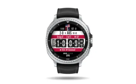 A Wear OS smartwatch displays live World Cup 2026 scores and tournament updates.