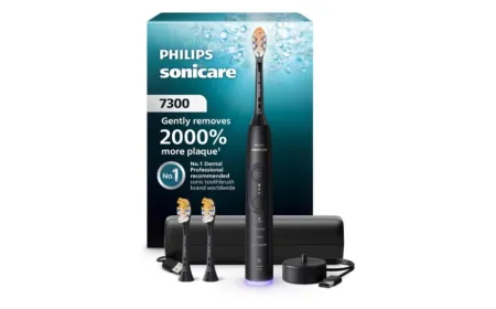 The Philips Sonicare 7300 Series electric toothbrush rests on its charging base with brush heads nearby.