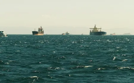 Commercial vessels navigate the Strait of Hormuz following a diplomatic agreement to resume safe maritime passage.