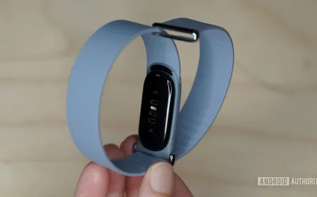 A Fitbit Air band is attached to an analog watch by slipping through the spring bars after removing the original strap.