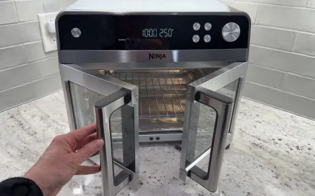Front view of the Ninja French Door Air Fryer and Countertop Oven showing its control panel and glass door.