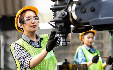 Automated machinery and digital interface displays in a modern manufacturing facility.