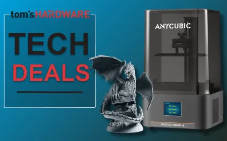 An entry level resin 3D printer sits on a workbench to illustrate affordable desktop fabrication.