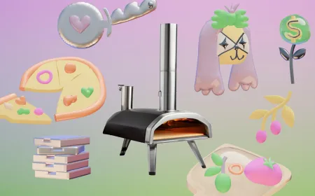 A compact portable pizza oven burns wood fuel during an outdoor cooking session.