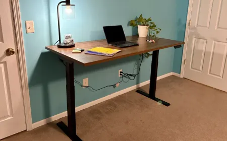 A height adjustable desk features a smooth motorized lift mechanism and a digital control panel.