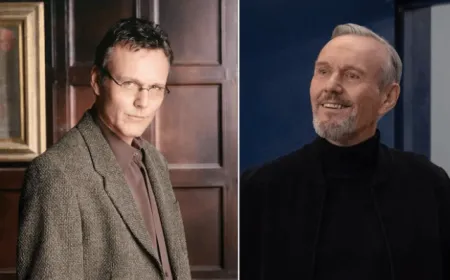 British actor Anthony Head poses in a dark suit against a neutral background during a professional photoshoot.