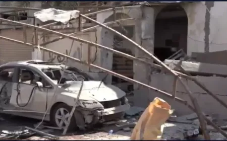 Scorched cars and damaged homes are visible following drone strikes on Bahrain.