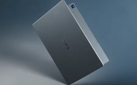 The silver Dell XPS 13 laptop is displayed open on a desk.