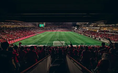 Security personnel manage crowd flow and monitor public zones outside a World Cup stadium.