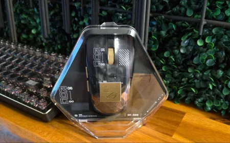 Gold and black Asus ROG Harpe II Extreme Edition 20 gaming mouse with a transparent back panel.