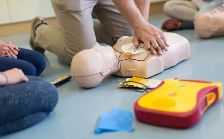 Emergency responders perform CPR while a bystander activates the medical response system.