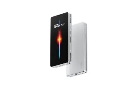 An AYANEO gaming phone is displayed during a hands-on review, showcasing its compact form and dedicated gaming controls.