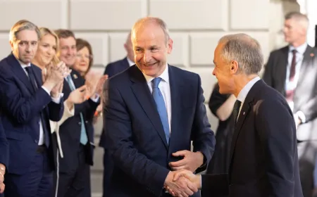 Prime Minister Mark Carney and Taoiseach Micheál Martin signing a joint statement on biomanufacturing partnership