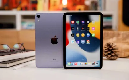 A compact tablet features a bright OLED display and narrow bezels representing the 2026 iPad mini design.