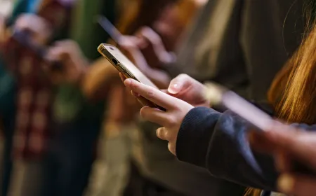 A smartphone displaying social media applications with a prohibition symbol