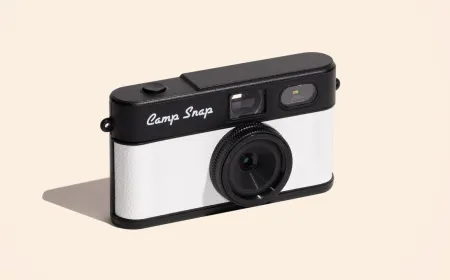 The Camp Snap 2 screen-free digital camera features a compact body, fixed lens, and dedicated filter toggle button.