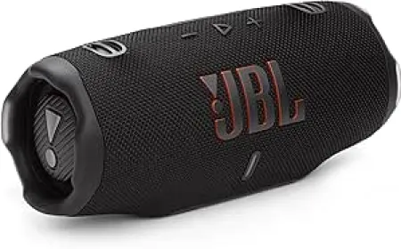 The photograph displays a modern wireless audio device highlighting its acoustic driver and charging interface.