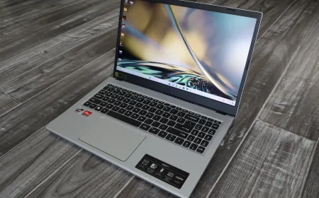 Several budget laptops under five hundred dollars rest on a desk.