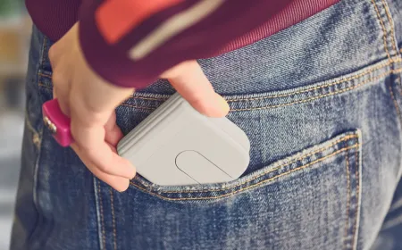 Logitech Mobi Fold wireless mouse shown folded for pocket storage, featuring a scroll trackpad and side buttons.