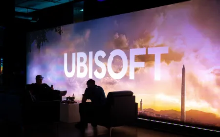 A corporate office building represents Ubisoft global studio restructuring efforts.