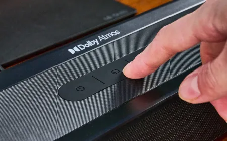 Audio engineers adjust mixing consoles for Dolby Atmos soundtracks.