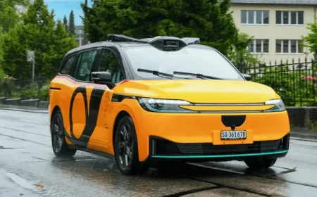 Baidu Apollo Go autonomous vehicle undergoing road testing alongside PostBus in Switzerland